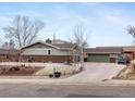 Well-kept home exterior with manicured lawn and two-car garage, perfect curb appeal at 6535 Brentwood St, Arvada, CO 80004