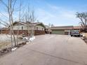 Charming exterior view of home with attached two-car garage and spacious driveway at 6535 Brentwood St, Arvada, CO 80004