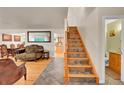 Inviting entryway with beautiful tile flooring, staircase, and convenient powder room at 7439 S Depew St, Littleton, CO 80128