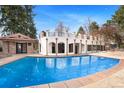 A stunning pool and patio, with an outdoor brick building, surrounded by a fence at 2111 E Alameda Ave, Denver, CO 80209