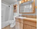 Functional bathroom featuring a tub/shower, vanity with wood cabinets, and a toilet at 1301 Speer Blvd # 1008, Denver, CO 80204