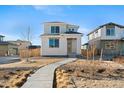 Charming two-story home featuring drought tolerant landscaping and inviting walkway at 21134 E 63Rd Dr, Aurora, CO 80019