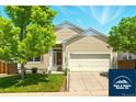 Charming two-story home with landscaped front yard and attached two-car garage at 5720 S Tempe Ct, Aurora, CO 80015