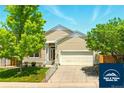 Charming two-story home with landscaped front yard and attached two-car garage at 5720 S Tempe Ct, Aurora, CO 80015
