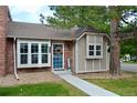 Inviting home with a brick and siding facade, well-maintained lawn, and a pleasant entryway at 9713 W Chatfield Ave # H, Littleton, CO 80128