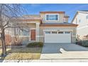 Charming two-story home with a two-car garage, covered entrance, and professionally landscaped front yard at 2520 E 127Th Ave, Thornton, CO 80241