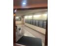 Well-lit hallway with mailboxes, neutral walls, and a glimpse into a clean, organized space at 8060 E Girard Ave # 504, Denver, CO 80231