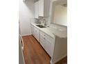 Bright kitchen features a modern sink, stainless steel faucet, and updated white cabinets at 8060 E Girard Ave # 504, Denver, CO 80231