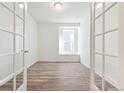 Bright office with wood floors, white walls, French doors and large window at 13412 E 110Th Way, Commerce City, CO 80022