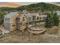 Exterior view of this home featuring a stone foundation, multi-level deck and green surroundings at 4749 Starfire Cir, Castle Rock, CO 80104