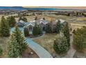 Beautiful front exterior view of home with circular driveway and professional landscaping at 4749 Starfire Cir, Castle Rock, CO 80104