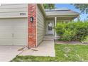 A cozy home with a well-kept lawn and red brick accents at 9705 Autumnwood Pl, Highlands Ranch, CO 80129