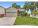Inviting home with a well-maintained front yard, covered porch, and two-car garage, ideal for a growing Gathering at 9705 Autumnwood Pl, Highlands Ranch, CO 80129