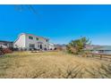 Expansive backyard with a well-manicured lawn and a view of the mountains at 9799 Falcon Ln, Littleton, CO 80125