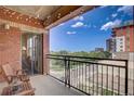 Relaxing outdoor balcony with lovely city views, featuring a bistro set and string lights for cozy evenings at 1975 Grant St # 501, Denver, CO 80203