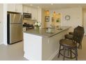 Modern kitchen features stainless steel appliances, a kitchen island with a sink, and pendant lighting at 1975 Grant St # 501, Denver, CO 80203