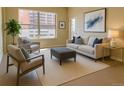 Bright living room featuring a neutral palette, large windows, and contemporary furniture at 1975 Grant St # 501, Denver, CO 80203