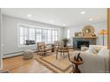 Bright living room with a fireplace, large bay window and bench, plus hardwood floors and modern decor at 2570 Bell Ct, Lakewood, CO 80215