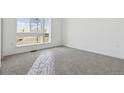 Bright bedroom with carpet floors and large windows offering natural light, perfect for a cozy retreat at 25224 E Warren Pl, Aurora, CO 80018