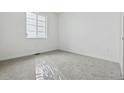 A minimalist bedroom boasts soft carpet, fresh white walls, and a window for ample natural light at 25224 E Warren Pl, Aurora, CO 80018