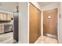 Apartment entryway with wood flooring, coat closet and kitchen peek at 9335 E Center Ave # 4B, Denver, CO 80247