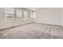 Cozy bedroom with soft carpeting and a large window at 15276 Fillmore St, Thornton, CO 80602
