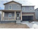 Charming two-story home with a welcoming front porch and stone accents on the garage at 15276 Fillmore St, Thornton, CO 80602