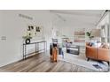 Bright living room with vaulted ceilings, modern decor, and stylish furniture at 1590 S Macon St, Aurora, CO 80012