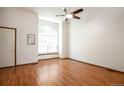Bright living room with beautiful hardwood floors and a large arch window at 7732 Xavier Ct, Westminster, CO 80030