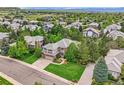 Gorgeous aerial view of a suburban house surrounded by lush greenery and other residences at 10529 Dacre Pl, Lone Tree, CO 80124