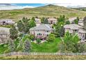 Stunning backyard view of a home with a deck overlooking a lush lawn and a white fence at 10529 Dacre Pl, Lone Tree, CO 80124