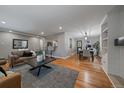 Open living space featuring hardwood floors, dining area, living area and bar seating at 395 Zephyr St, Lakewood, CO 80226