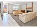 Bright living room showcasing sofas, a modern fireplace, and tiled entry at 5719 S Lowell Blvd, Littleton, CO 80123