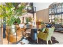 Eclectic seating area with round table, leather seating, and greenery, creating a unique atmosphere at 1203 24Th St, Denver, CO 80205
