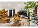 Stylish living room boasts exposed brick, a large television, and artistic wooden accents at 1203 24Th St, Denver, CO 80205