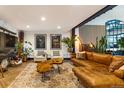 Cozy living room with a leather sofa, accent chairs, and unique art at 1203 24Th St, Denver, CO 80205
