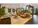 Bright living room with a leather sofa, chairs and unique wood accents at 1203 24Th St, Denver, CO 80205