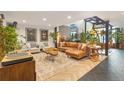 Spacious living room featuring a comfortable leather sectional sofa, eclectic decor, and herringbone floors at 1203 24Th St, Denver, CO 80205