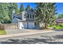 Two-story gray home with a two-car garage and mature trees at 4782 E Costilla Ave, Centennial, CO 80122