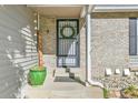 Welcoming front entrance with a decorative wreath and a lush green potted plant at 4782 E Costilla Ave, Centennial, CO 80122