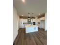 Modern kitchen with stainless steel appliances, pendant lighting, and a central island at 191 Washington St, Erie, CO 80516