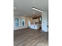 Spacious living room featuring wood floors that seamlessly transitions to the modern kitchen at 191 Washington St, Erie, CO 80516