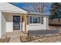 Front entry with a modern door and wood post at 4441 E Montana Pl, Denver, CO 80222