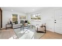 Bright and airy living room with hardwood floors and large windows at 4441 E Montana Pl, Denver, CO 80222