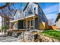 Inviting two-story home with a covered front porch and professionally landscaped yard at 4125 Tejon St, Denver, CO 80211