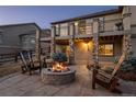 Backyard patio with outdoor fireplace and comfortable seating, perfect for entertaining at 2891 Waterfront Dr, Monument, CO 80132