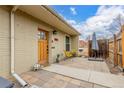 Inviting patio area with a wooden front door, comfortable seating, and a peaceful outdoor ambiance at 2841 N Columbine St, Denver, CO 80205