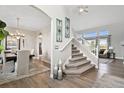 Inviting foyer with hardwood floors, staircase, and views into the dining and living areas at 2550 Gold Creek Dr, Elizabeth, CO 80107