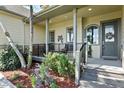 Charming covered front porch with seating, beautiful landscaping, and a welcoming entrance at 2550 Gold Creek Dr, Elizabeth, CO 80107