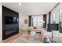 Bright living room boasts modern fireplace, stylish decor, and abundant natural light through large windows at 2907 Distant Rock Ave, Castle Rock, CO 80109